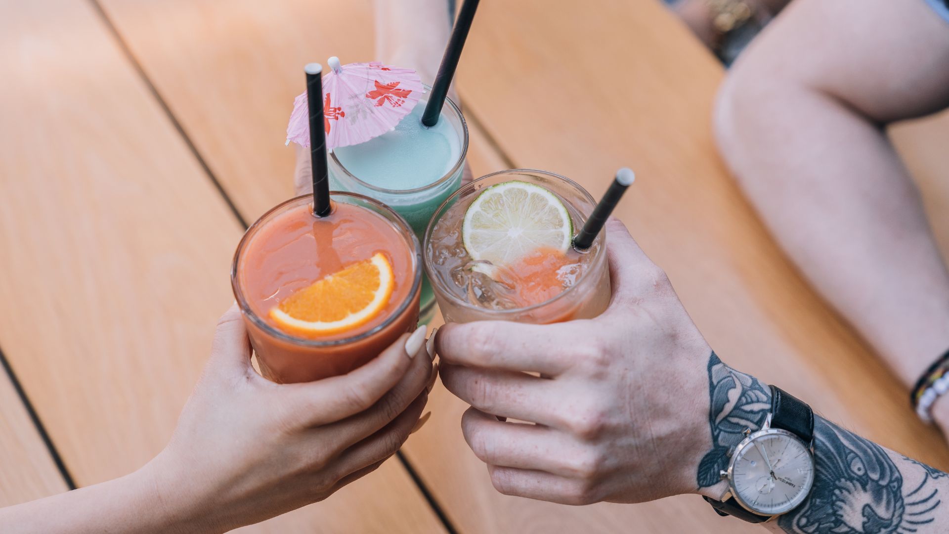 Three friends cheersing during summer